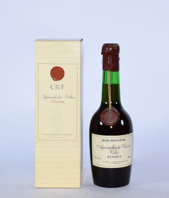 une vieille bouteille de vin posée à côté d'un carton de vin