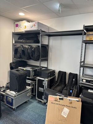 une pièce remplie de nombreux bagages et d'une étagère