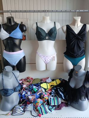 several mannequins and lingersuits on display in a clothing store