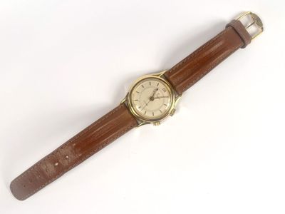 wrist watch with brown leather strap on white surface with white background