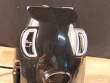 a coffee maker that is sitting on a wooden table