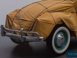 a car covered with a tarp sitting in a garage