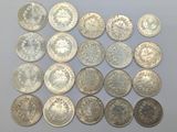 a close up of a pile of silver coins on a table