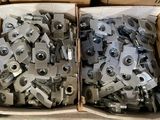 two boxes filled with metal parts sitting on top of a table