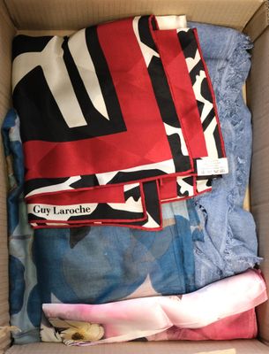 a box full of clothing that is sitting on the floor