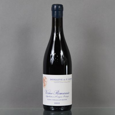 a bottle of wine sitting on a glass table