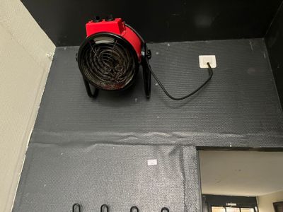a red fire hydrant sitting on top of a black wall