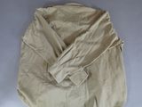 an image of a beige shirt with a button down collar