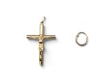 a gold cross and a ring on a white surface