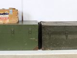 two trunks sitting on top of each other on a table