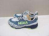 the shoe is blue and white with a green logo on the side