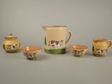 four pieces of pottery with a cow design on them