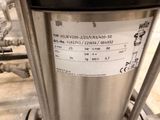 a close up of a stainless steel tank with a label on it