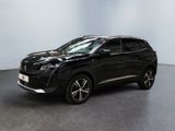 un SUV noir garé dans une pièce aux murs blancs