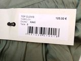 a label on a dress that says top clovers