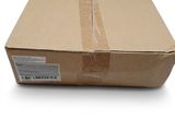 une boîte en carton sur fond blanc, avec un autocollant sur le côté