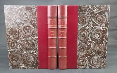 two red books sitting on top of each other on a table