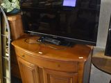 a tv that is sitting on a stand in a room