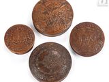 three small wooden buttons with ornate designs on them on a white surface