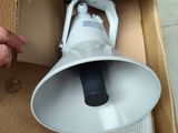 a person opening a box with a speaker inside of it