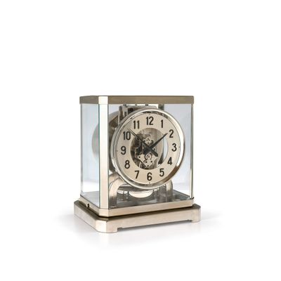 a clock that is sitting in a glass case
