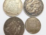 four different types of coins sitting on top of a white surface
