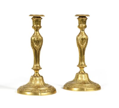 pair of antique brass candlesticks on a white background