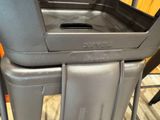 a black trash can sitting on top of a metal cart
