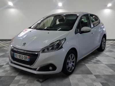 the small white car is parked in a large room