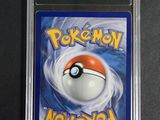 a close up of a pokemon card on a black surface