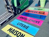 a fork lift truck parked in front of a parking lot