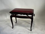un petit banc en bois avec une assise en cuir rouge