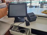 a monitor and a printer on a desk in a room