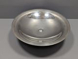 a silver bowl on a table with a white background