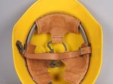 a yellow hard hat with a yellow strap on it