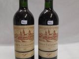 two bottles of wine sitting next to each other on a table