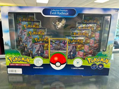 display case of pokemon cards and collectibles on a table in a store