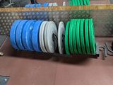 a lot of green and blue discs stacked on a shelf