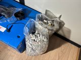 two bags of pills sitting on the floor next to a blue box