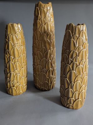 three vases that are sitting on a table
