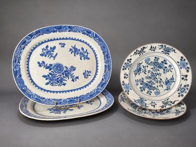 two blue and white plates with floral designs on them