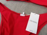 a close up of a red bikini top with a tag on it