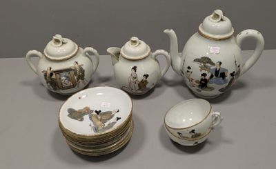 a white tea pot with a cup and saucer on it