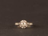 bague de fiançailles en or blanc ornée d'un diamant rond de taille brillant