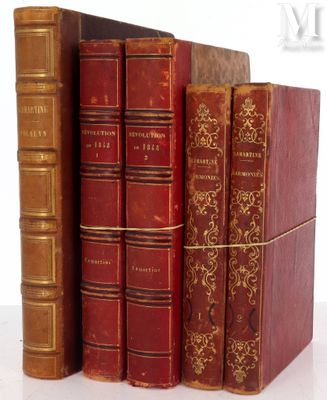 several old books are stacked on top of each other on a table