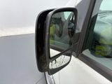 a man taking a picture of himself in the side view mirror of a car