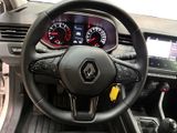 the steering wheel and dashboard of a car with a clock on it