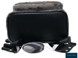 a small black bag with a stuffed animal in it