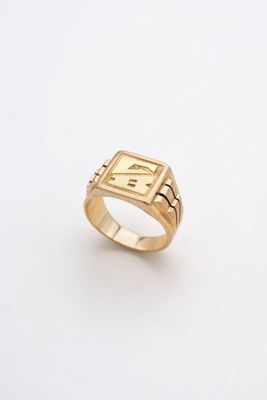 a gold ring with a roman numeral on it