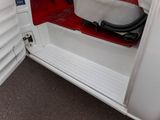 a white truck with a red seat and door open